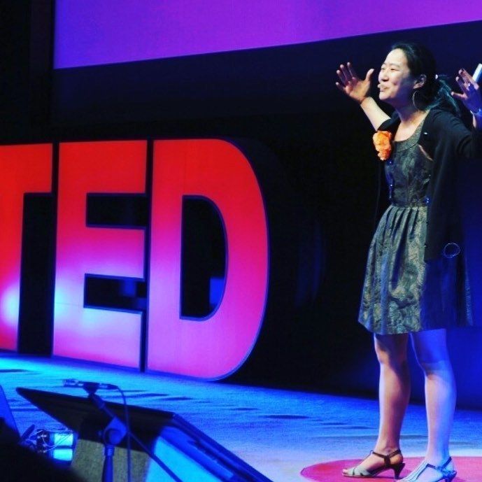 Global Happiness Coach and WITH Warrior Kyla Mitsunaga speaking on the TED stage