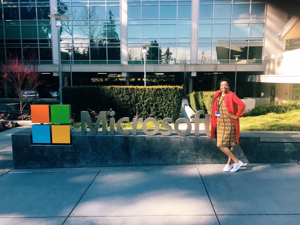 April is standing in front of the Microsoft sign on her first day at Microsoft.