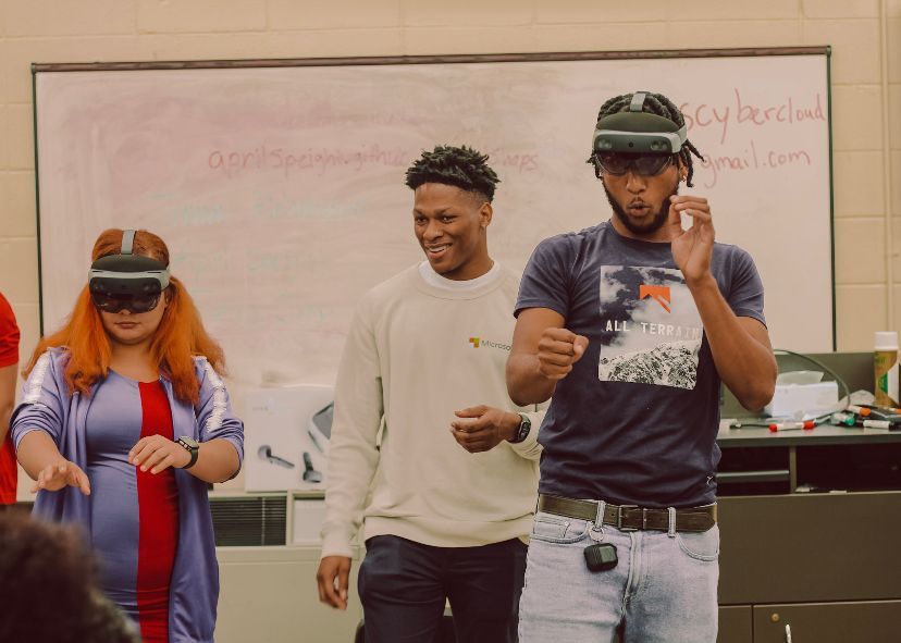 Jared Shepherd with two students trying out a HoloLens 2.