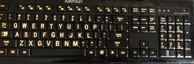 Image of a High Contrast Keyboard Laptop 4 marked with Surface Adaptive Kit. Keyboard does not have a num pad, and is marked with an X on the Capslock key and a dot on the "C" key