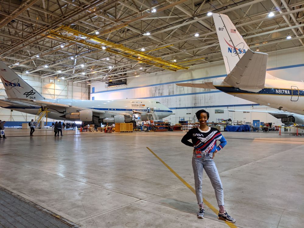 April standing in front of airplanes at NASA Armstrong