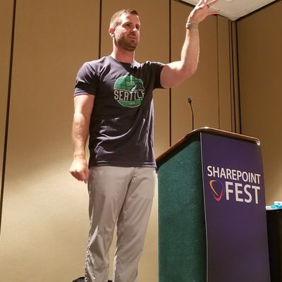 Fun, past pic of our guest, Drew Madelung, presenting “Sharing Strategy” back in the days of SharePoint Fest 2019, the previous (previous) name of TechCon365. Did you note the similari-tee?