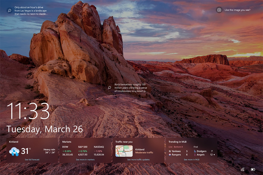 An example of weather, finance, traffic, and sports cards on the Windows 10 lock screen. The cards are aligned to the left and located in a row on the bottom of the screen.