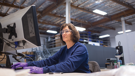 Person working at their monitor in a warehouse