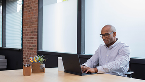 Person in an office working at their laptop