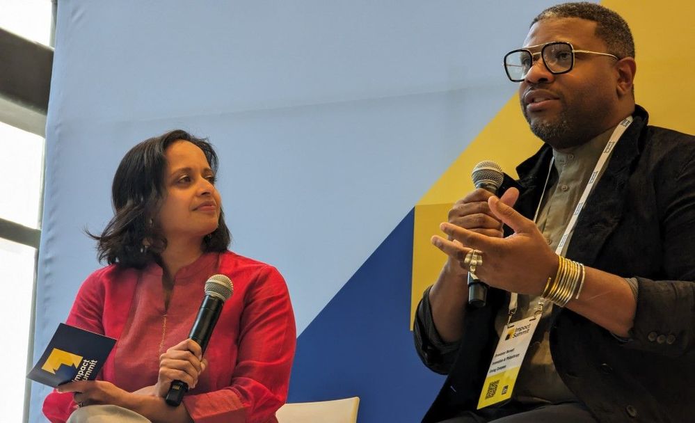 Devi Thomas and Brandolon Barnett on stage talking to an audience.