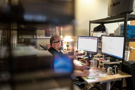 Nonprofit Leader sitting at desk handling daily operations