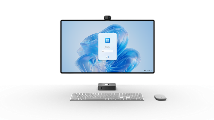 Image of a Windows 365 Link pictured along with a large monitor, slim keyboard, and modern mouse