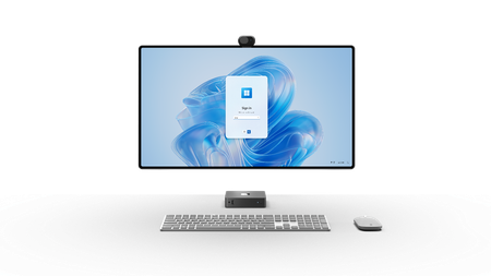 Image of a Windows 365 Link pictured along with a large monitor, slim keyboard, and modern mouse