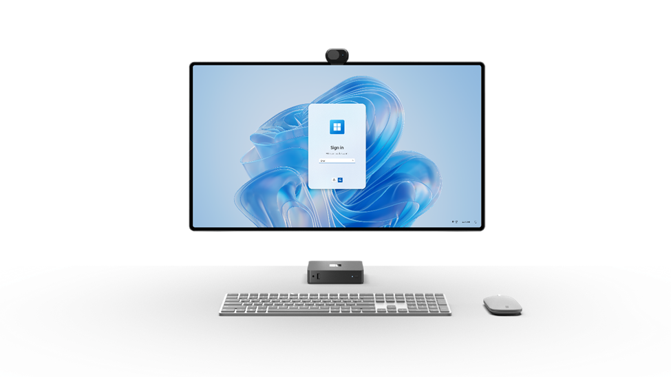 Image of a Windows 365 Link pictured along with a large monitor, slim keyboard, and modern mouse