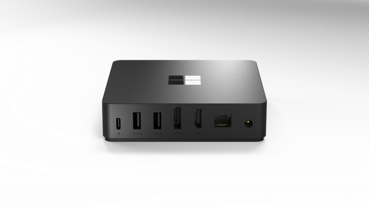 Back view of Windows 365 Link (cube shape) with various ports including USB, ethernet, and headphone