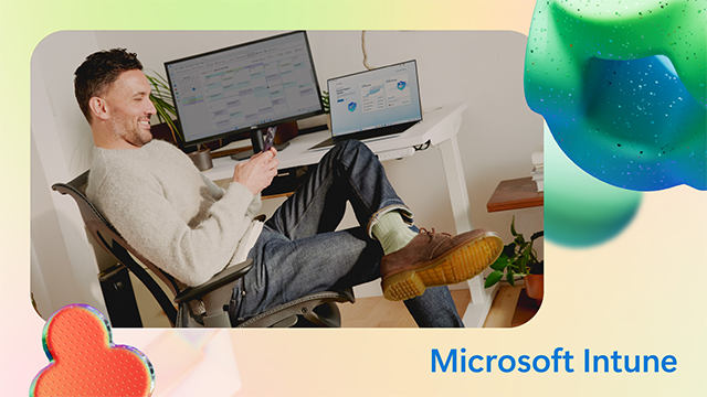 Microsoft Intune on yellow background; man looks at his phone, sitting in a chair in front of desk with computer.