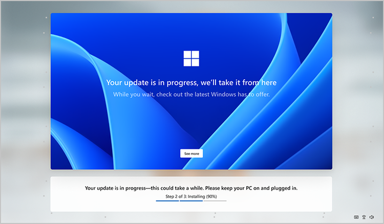 Mockup of the Windows screen during OOBE. Text notes that update is in progress. Background is the varied blues of the Windows bloom.