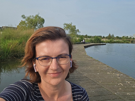 A woman with classes in a striped shirt