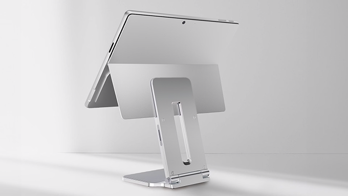 A Surface Pro device mounted on Kensington’s Elevated Stand, a sleek and modern aluminum stand designed for Surface 2-in-1 devices. The stand elevates the device for improved ergonomics and workspace efficiency, with a minimalist and sturdy design.