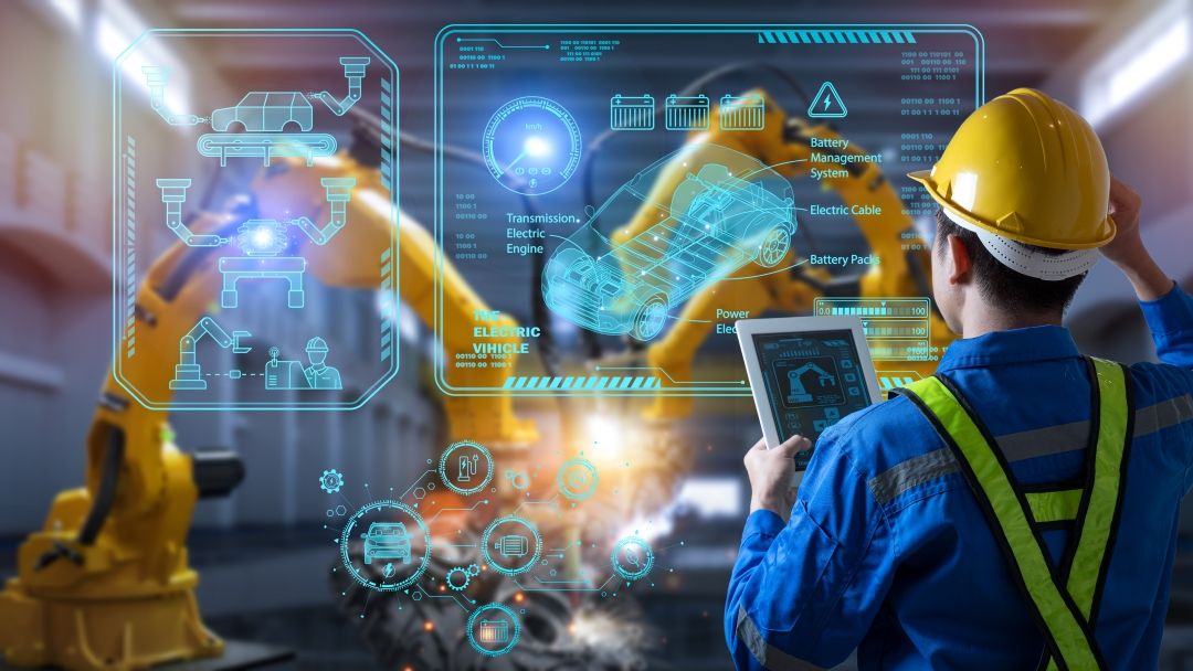 Engineer control robotics automatic arms machine welding Electric Vehicle car at factory in intelligent factory automotive industrial with tablet monitoring system software.