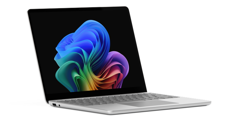 Surface Laptop for Business, 13-inch shown open at an angle, featuring a colorful Copilot+ PC wallpaper on screen.