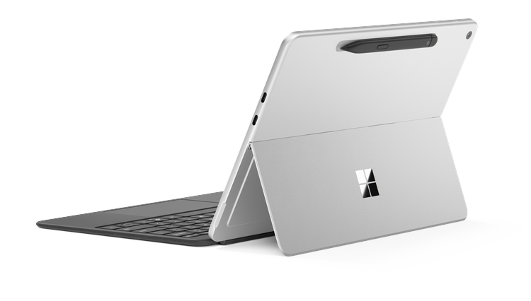 Rear view of Surface Pro for Business, 12-inch in kickstand mode with attached keyboard and Surface Slim Pen magnetically docked, highlighting its portability and modular design.