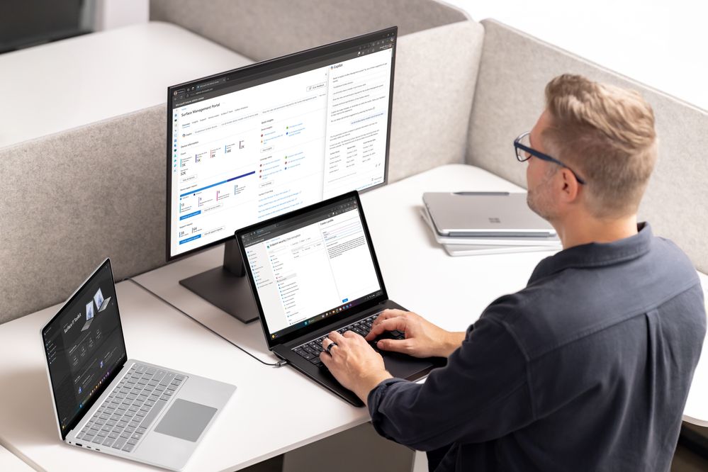 A man using a Surface Laptop to access the Surface Management Portal and Copilot