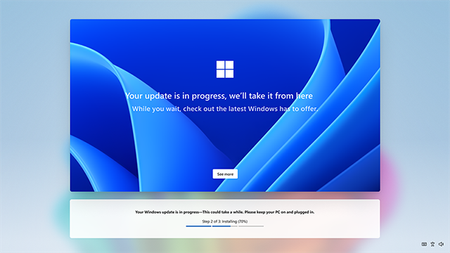 Screenshot of the final OOBE screen with in-progress Windows update message. Background is the Windows bloom in gradients of blue with white Microsoft logo in middle of screen.