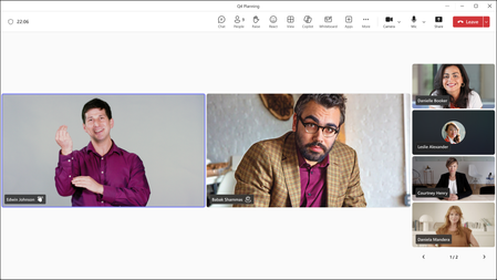 Sign Language View in Microsoft Teams, showing two Sign Language users prioritized at the center of the meeting window. The user on the left is detected using sign language and has the active speaker border around their video tile.