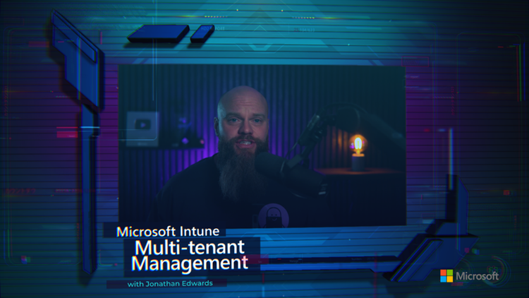 a still image of a bearded man speaking into a microphone accompanied by text