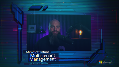 a still image of a bearded man speaking into a microphone accompanied by text