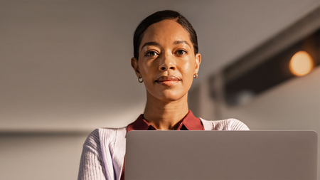 An IT administrator stares confidently at the camera