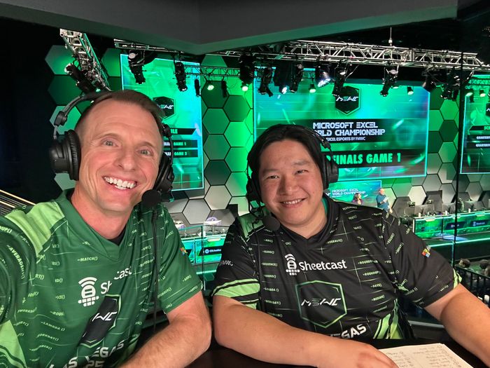A picture of two men wearing headsets with a laptop computer giving commentary on the Microsoft Excel World Championship
