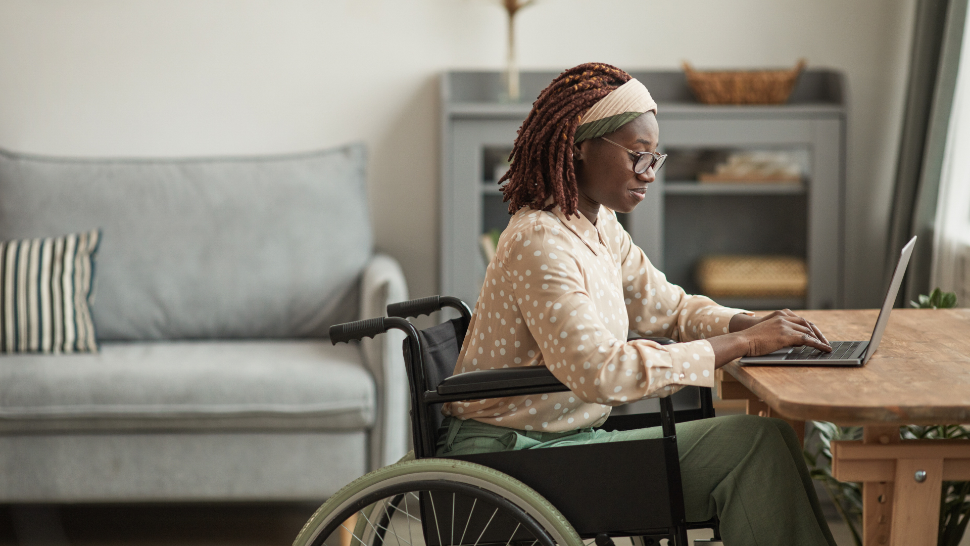An IT professional works on a laptop in her home office.