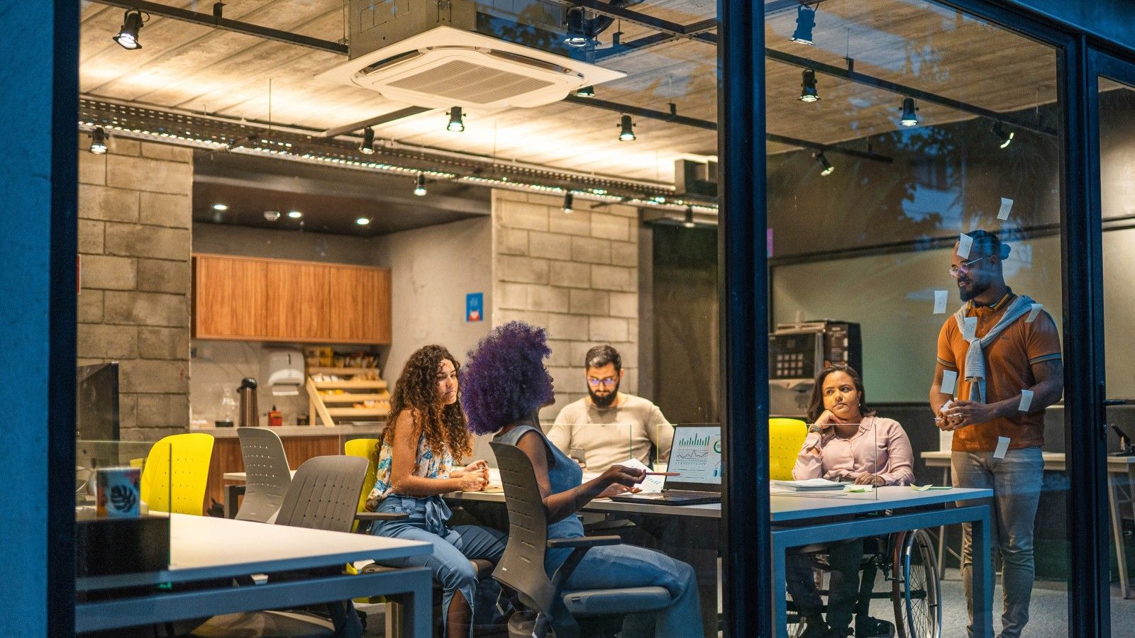 Colleagues discuss in a casual workspace