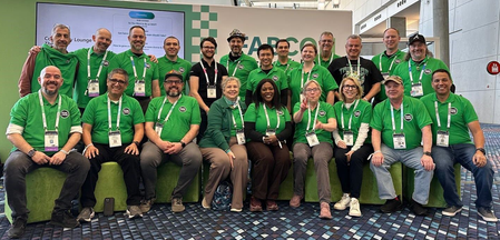 An image of a group of men and women at a conference