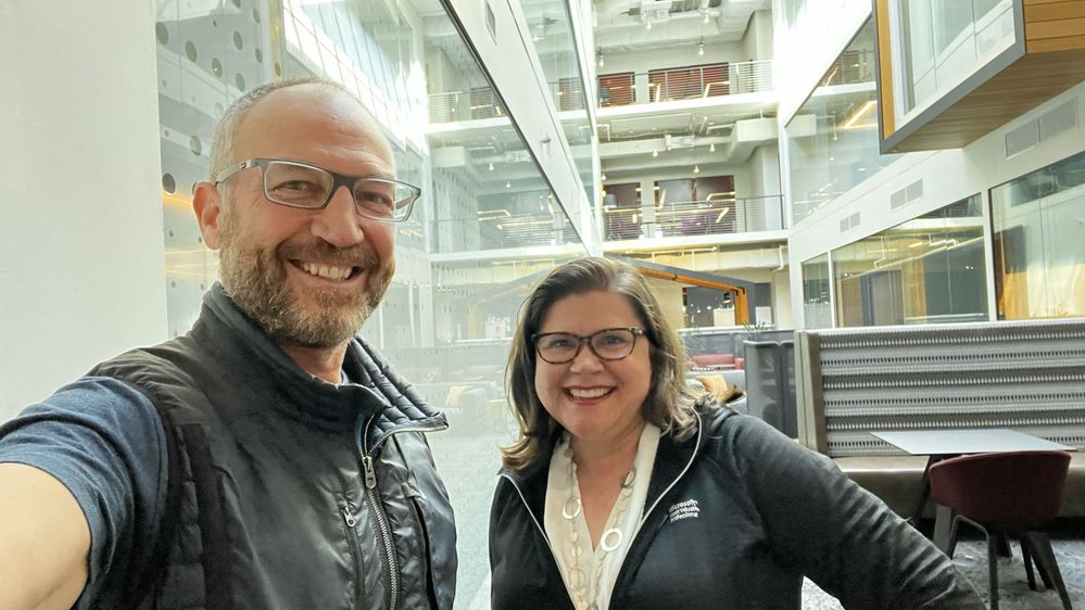 The Intrazone host and guest, left-to-right: Mark Kashman (Senior product manager – Microsoft) [Host and selfie arm] with Amy Dolzine Microsoft alliance relationship director for the Americas at EY and Microsoft MVP [guest] – after the interview in the building 122 atrium on the Microsoft Redmon, WA campus.